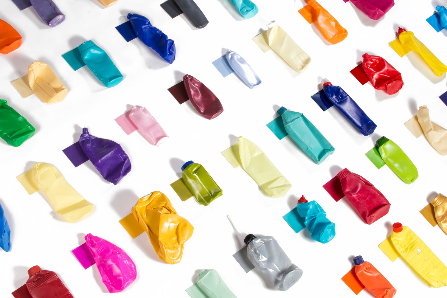 Recycled material. Colourful, empty paint tubes, taped to white canvas. Photo credit: JESSICA DEN HARTOG.
