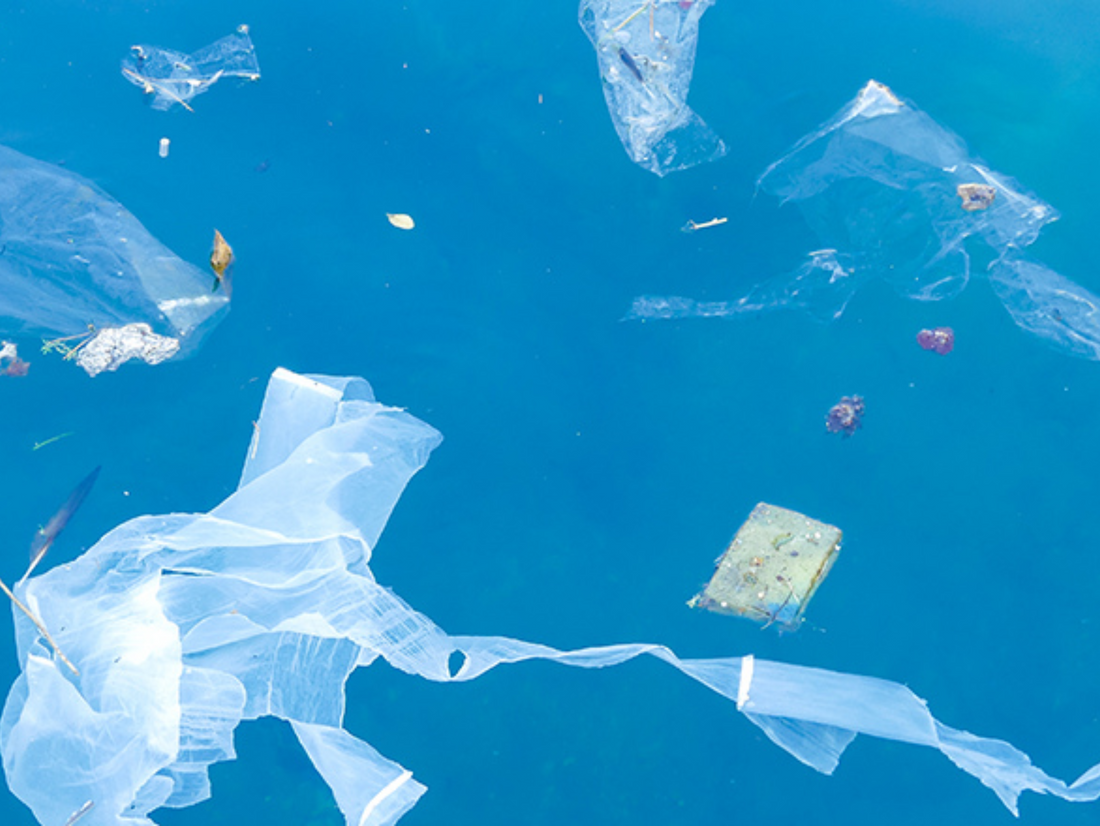 Plastic in the ocean. Image of plastic waste floating in the ocean.